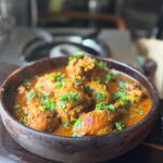 Savor the rich flavors of homemade Indian chicken curry garnished with cilantro. Perfect for food lovers.