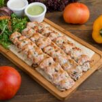 Sizzling grilled chicken kebabs served with fresh vegetables and sauces.