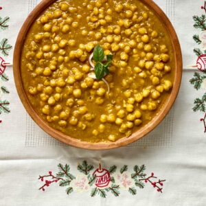 Delicious chana masala placed on a decorative embroidered cloth, showcasing traditional Indian cuisine.